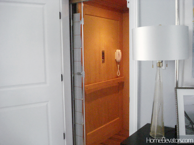 Home elevator phone mounted on cab wall